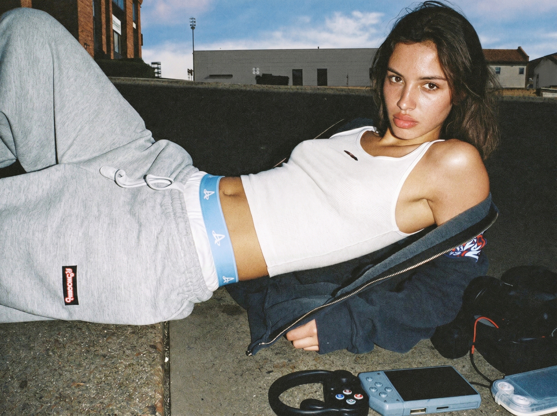 Close editorial crop of Action Replay boxers styled with grey sweats and gaming hardware.